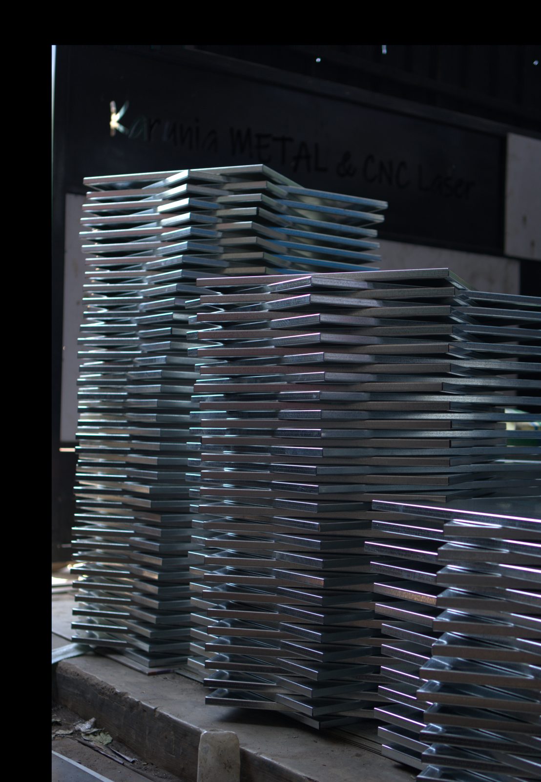 Stacked precision-cut metal plates in the workshop